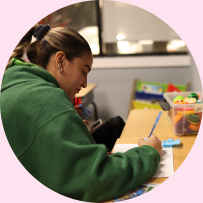 A teacher writing in a koala aba classroom, the best aba therapy center in Florida